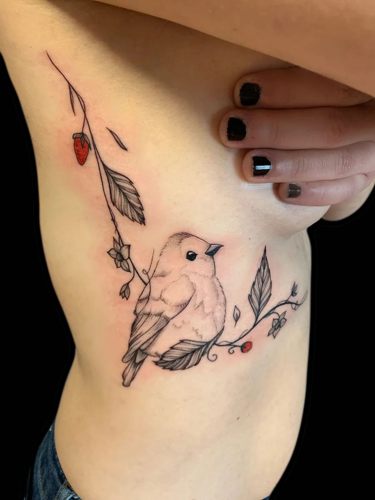 Tatouage oiseau canari et branche fraises fine line sur côtes — studio Annahata